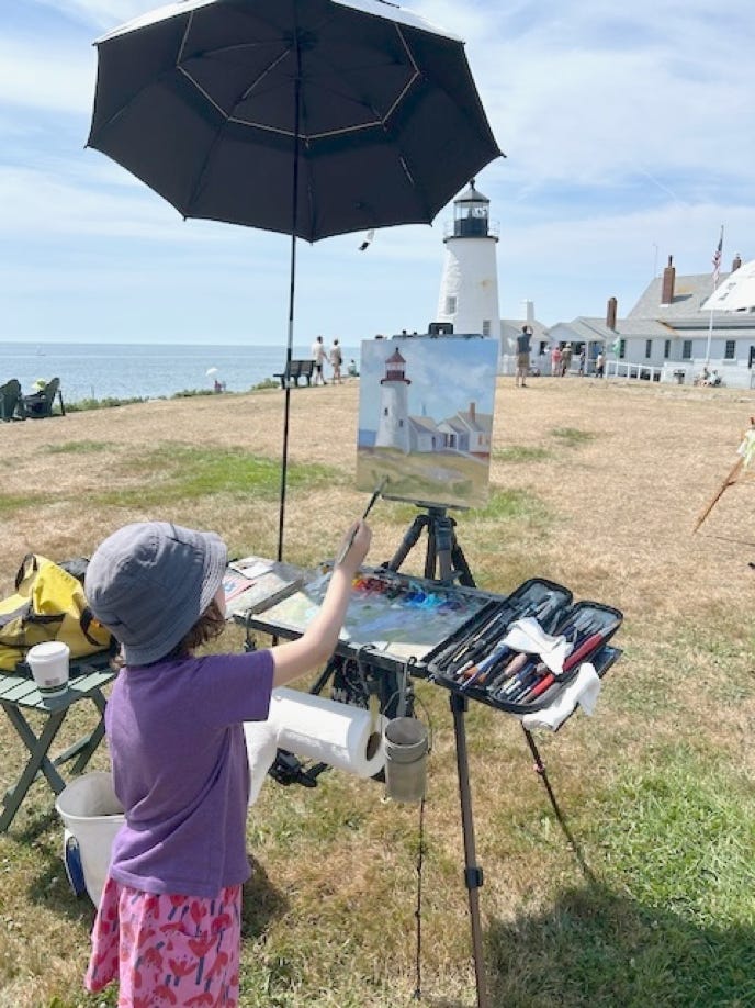  A young visitor was given a painting lesson.